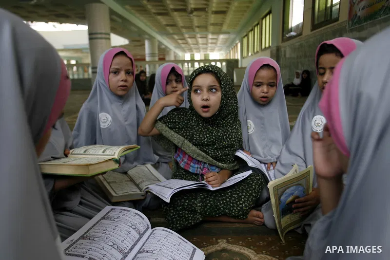 Palestinian girls read the holy Qur'an at mosque in Rafah in southern Gaza strip, on 29 July 2012. Muslims around the world refrain from eating, drinking and sexual intercourse from dawn till dusk during Ramadan, the hol...