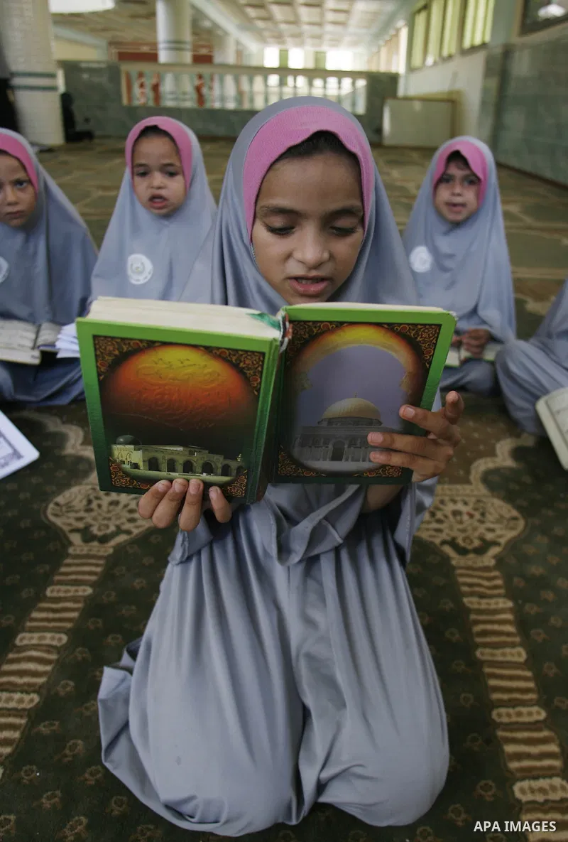 Palestinian girls read the holy Qur'an at mosque in Rafah in southern Gaza strip, on 29 July 2012. Muslims around the world refrain from eating, drinking and sexual intercourse from dawn till dusk during Ramadan, the hol...