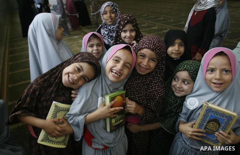 Palestinian girls read the holy Qur'an at mosque in Rafah in southern Gaza strip, on 29 July 2012. Muslims around the world refrain from eating, drinking and sexual intercourse from dawn till dusk during Ramadan, the hol...