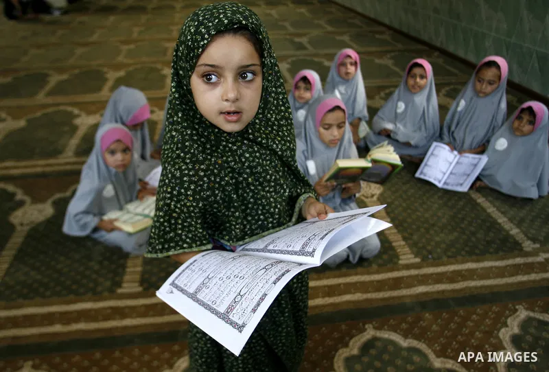 Palestinian girls read the holy Qur'an at mosque in Rafah in southern Gaza strip, on 29 July 2012. Muslims around the world refrain from eating, drinking and sexual intercourse from dawn till dusk during Ramadan, the hol...