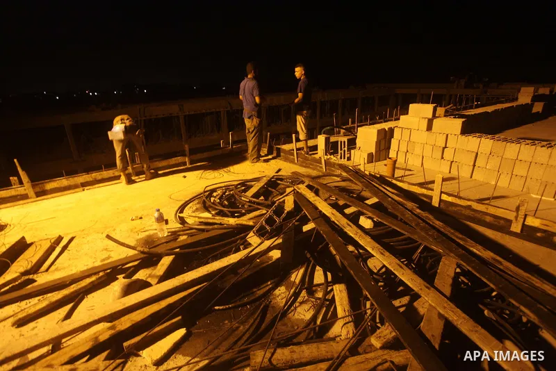 Palestinian construction workers work at night in Deir al-Balah in central Gaza Strip on 29 July 2012. Palestinian construction workers work during the night in the month of Ramadan because of the high temperatures they...