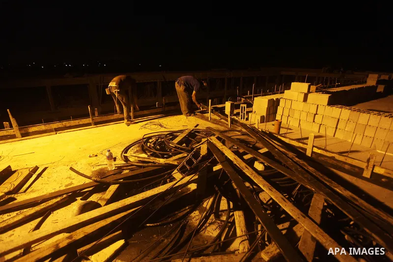 Palestinian construction workers work at night in Deir al-Balah in central Gaza Strip on 29 July 2012. Palestinian construction workers work during the night in the month of Ramadan because of the high temperatures they...