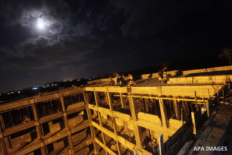 Palestinian construction workers work at night in Deir al-Balah in central Gaza Strip on 29 July 2012. Palestinian construction workers work during the night in the month of Ramadan because of the high temperatures they...