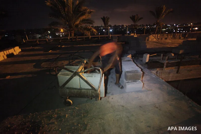 Palestinian construction workers work at night in Deir al-Balah in central Gaza Strip on 29 July 2012. Palestinian construction workers work during the night in the month of Ramadan because of the high temperatures they...