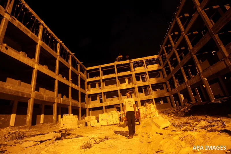 Palestinian construction workers work at night in Deir al-Balah in central Gaza Strip on 29 July 2012. Palestinian construction workers work during the night in the month of Ramadan because of the high temperatures they...