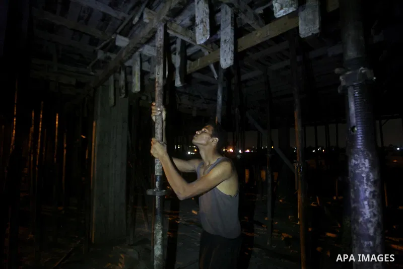 Palestinian construction workers work at night in Deir al-Balah in central Gaza Strip on 29 July 2012. Palestinian construction workers work during the night in the month of Ramadan because of the high temperatures they...