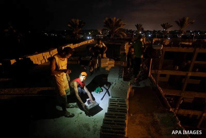 Palestinian construction workers work at night in Deir al-Balah in central Gaza Strip on 29 July 2012. Palestinian construction workers work during the night in the month of Ramadan because of the high temperatures they...