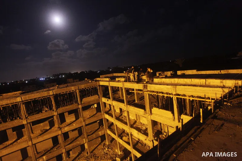 Palestinian construction workers work at night in Deir al-Balah in central Gaza Strip on 29 July 2012. Palestinian construction workers work during the night in the month of Ramadan because of the high temperatures they...