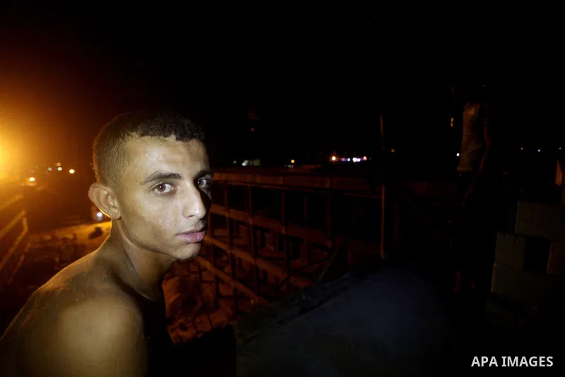 Palestinian construction workers work at night in Deir al-Balah in central Gaza Strip on 29 July 2012. Palestinian construction workers work during the night in the month of Ramadan because of the high temperatures they...