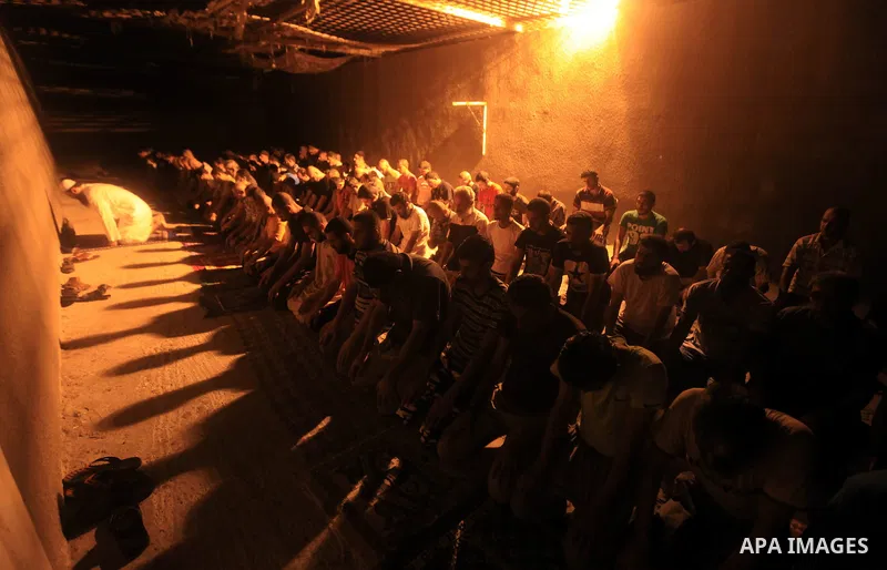 Palestinian inmates participate a prayer during the holy month of Ramadan at prison controlled by the Hamas police in Gaza city on 29 July 2012. Hamas police released more than 150 criminal inmates before the fasting mon...