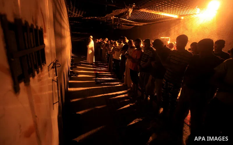 Palestinian inmates participate a prayer during the holy month of Ramadan at prison controlled by the Hamas police in Gaza city on 29 July 2012. Hamas police released more than 150 criminal inmates before the fasting mon...