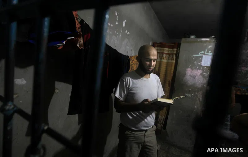 A Palestinian reads holy Qur'an inside his cell during the holy month of Ramadan at prison controlled by the Hamas police in Gaza city on 29 July 2012. Hamas police released more than 150 criminal inmates before the fast...