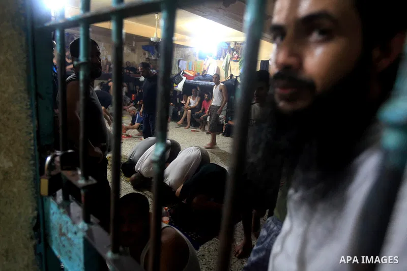 Palestinian inmates participate a prayer during the holy month of Ramadan at prison controlled by the Hamas police in Gaza city on 29 July 2012. Hamas police released more than 150 criminal inmates before the fasting mon...