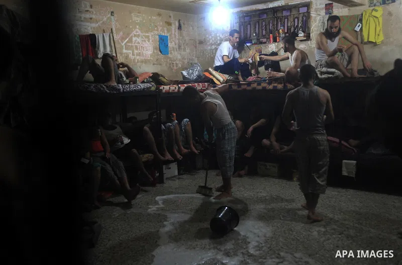Palestinian inmates clean their cell during the holy month of Ramadan at prison controlled by the Hamas police in Gaza city on 29 July 2012. Hamas police released more than 150 criminal inmates before the fasting month o...