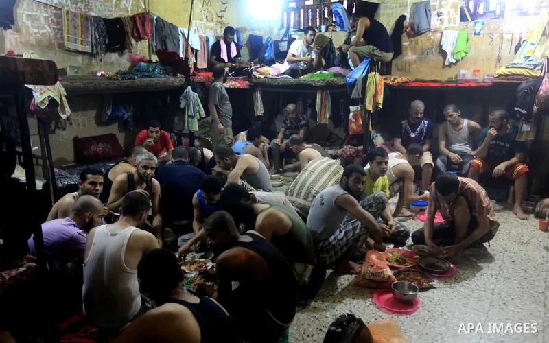 Palestinian inmates break their fast during the holy month of Ramadan at prison controlled by the Hamas police in Gaza city on 29 July 2012. Hamas police released more than 150 criminal inmates before the fasting month o...