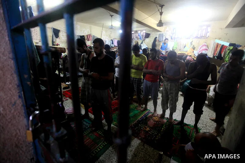 Palestinian inmates participate a prayer during the holy month of Ramadan at prison controlled by the Hamas police in Gaza city on 29 July 2012. Hamas police released more than 150 criminal inmates before the fasting mon...