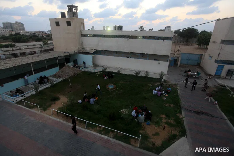 Palestinian inmates break their fast with their families during the holy month of Ramadan at prison controlled by the Hamas police in Gaza city on 29 July 2012. Hamas police released more than 150 criminal inmates before...