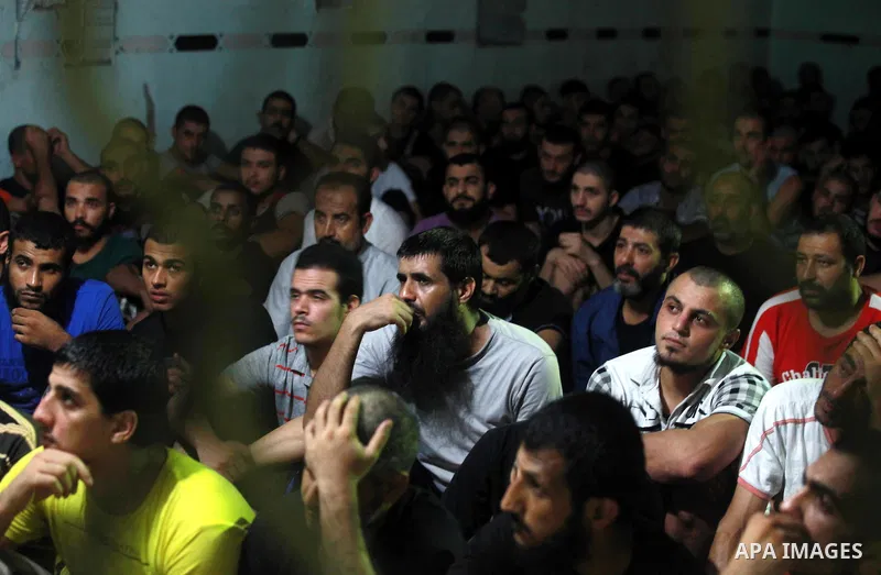 Palestinian inmates participate a prayer during the holy month of Ramadan at prison controlled by the Hamas police in Gaza city on 29 July 2012. Hamas police released more than 150 criminal inmates before the fasting mon...
