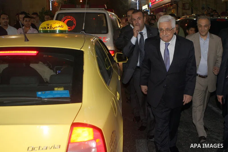 Palestinian President Mahmoud Abbas (abu mazen) walks in a street during a tour of Ramallah city in the West Bank in the holy month of Ramadan, on 29 July 2012. Photo by Thaer Ganaim