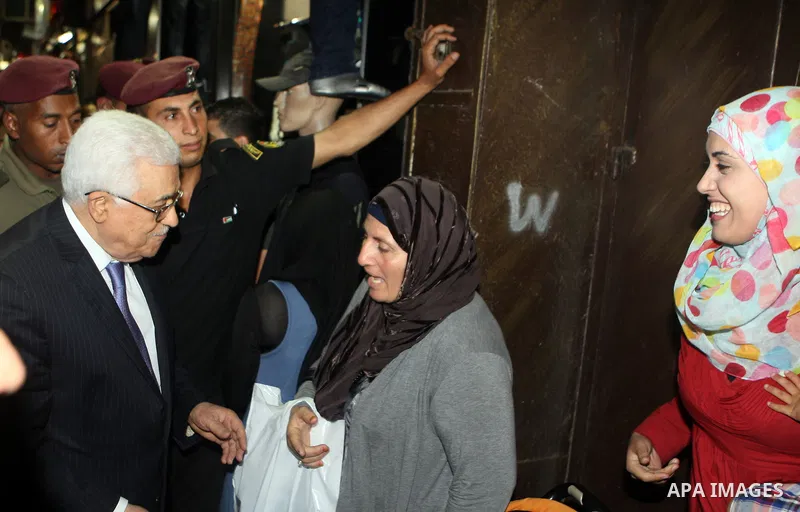 Palestinian President Mahmoud Abbas (abu mazen) shakes hand with a woman during a tour of Ramallah city in the West Bank in the holy month of Ramadan, on 29 July 2012. Photo by Thaer Ganaim