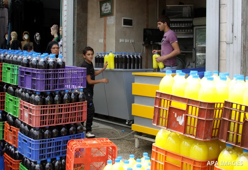 A Palestinian vendor sells bottles of juice in his shop in West Bank city of Nablus on July 30, 2012. Muslims throughout the world are celebrating the fasting month of Ramadan, the holiest month in the Islamic calendar,...
