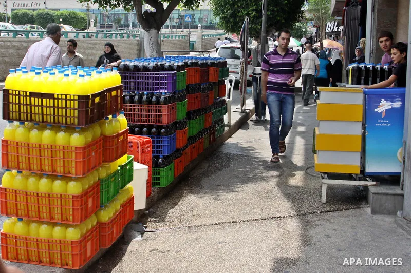 A Palestinian vendor sells bottles of juice in his shop in West Bank city of Nablus on July 30, 2012. Muslims throughout the world are celebrating the fasting month of Ramadan, the holiest month in the Islamic calendar,...