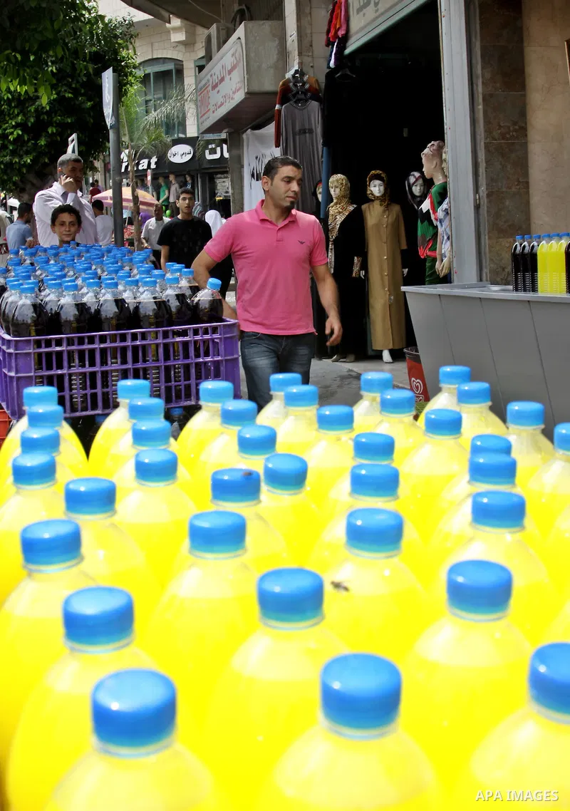 A Palestinian vendor sells bottles of juice in his shop in West Bank city of Nablus on July 30, 2012. Muslims throughout the world are celebrating the fasting month of Ramadan, the holiest month in the Islamic calendar,...