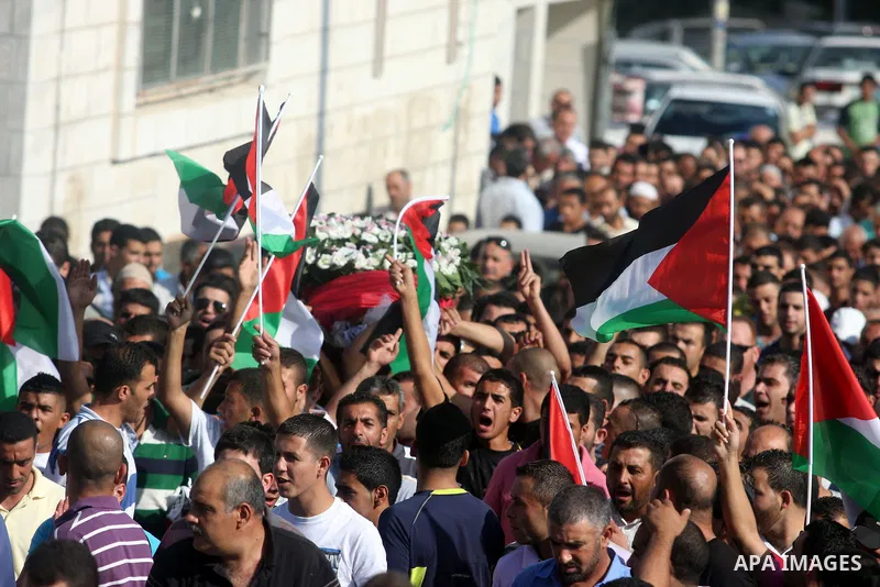 Palestinian mourners carry the body of Akram Badr, 46, during his funeral in the village of Beitillu near in the West Bank city of Ramallah, Tuesday, July 31, 2012. Badr was killed at a checkpoint by the Israeli security...