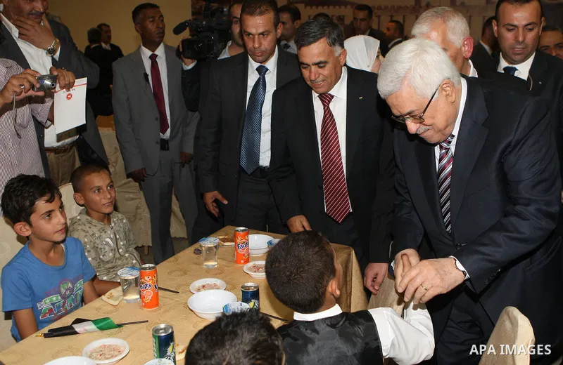 Palestinian President, Mahmoud Abbas (Abu Mazen), participates in breakfast with the group of Palestinian orphans in the West Bank city of Hebron on, Aug. 01, 2012. Photo by Thaer Ganaim