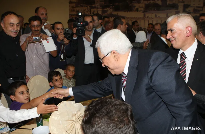 Palestinian President, Mahmoud Abbas (Abu Mazen), participates in breakfast with the group of Palestinian orphans in the West Bank city of Hebron on, Aug. 01, 2012. Photo by Thaer Ganaim
