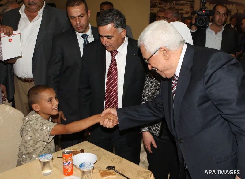 Palestinian President, Mahmoud Abbas (Abu Mazen), participates in breakfast with the group of Palestinian orphans in the West Bank city of Hebron on, Aug. 01, 2012. Photo by Thaer Ganaim