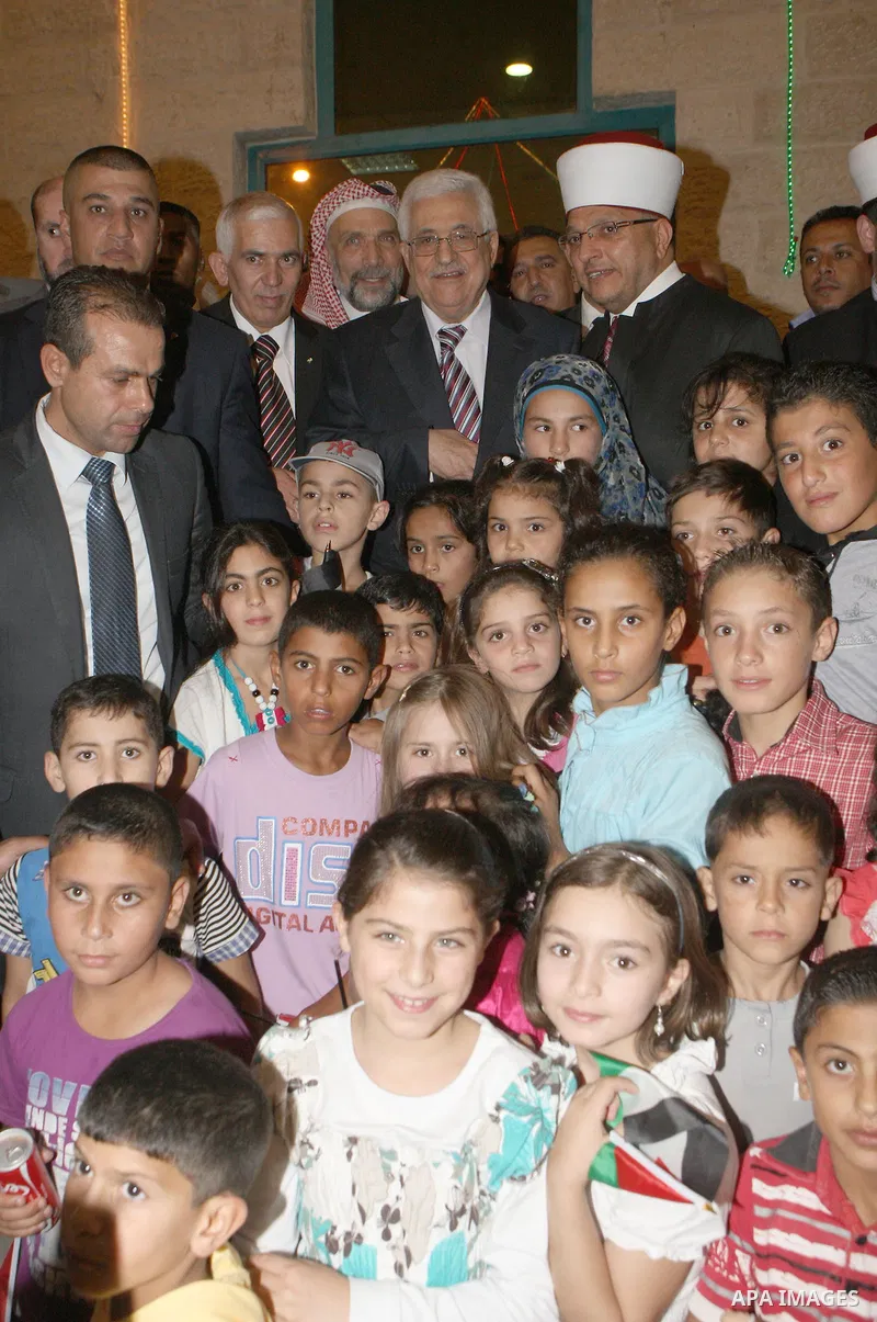 Palestinian President, Mahmoud Abbas (Abu Mazen), participates in breakfast with the group of Palestinian orphans in the West Bank city of Hebron on, Aug. 01, 2012. Photo by Thaer Ganaim