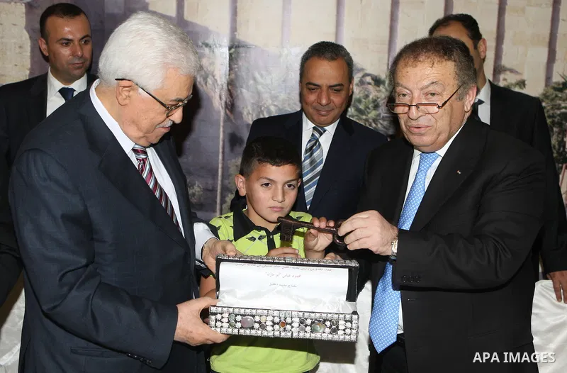 Palestinian President, Mahmoud Abbas (Abu Mazen), participates in breakfast with the group of Palestinian orphans in the West Bank city of Hebron on, Aug. 01, 2012. Photo by Thaer Ganaim