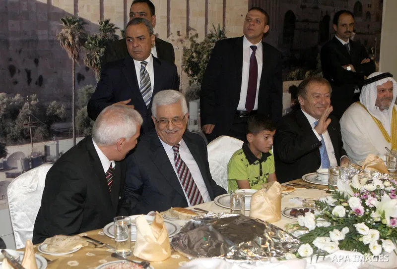 Palestinian President, Mahmoud Abbas (Abu Mazen), participates in breakfast with the group of Palestinian orphans in the West Bank city of Hebron on, Aug. 01, 2012. Photo by Thaer Ganaim
