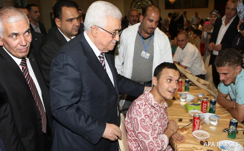 Palestinian President, Mahmoud Abbas (Abu Mazen), participates in breakfast with the group of Palestinian orphans in the West Bank city of Hebron on, Aug. 01, 2012. Photo by Thaer Ganaim