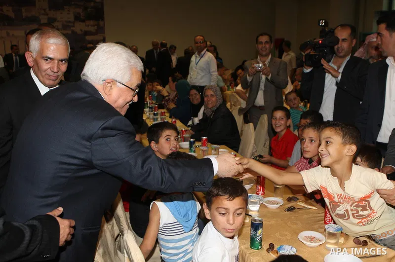Palestinian President, Mahmoud Abbas (Abu Mazen), participates in breakfast with the group of Palestinian orphans in the West Bank city of Hebron on, Aug. 01, 2012. Photo by Thaer Ganaim