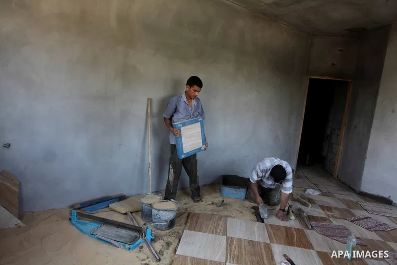 Palestinian laborers work in flooring during the holy month of Ramadan, in Deir al-Balah in central Gaza Strip on 02 August 2012. During Ramadan, eating, drinking, sex and smoking is banned and restaurants are forbidden...