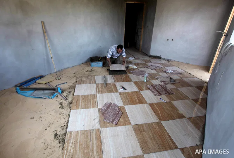 A Palestinian laborer works in flooring during the holy month of Ramadan, in Deir al-Balah in central Gaza Strip on 02 August 2012. During Ramadan, eating, drinking, sex and smoking is banned and restaurants are forbidde...