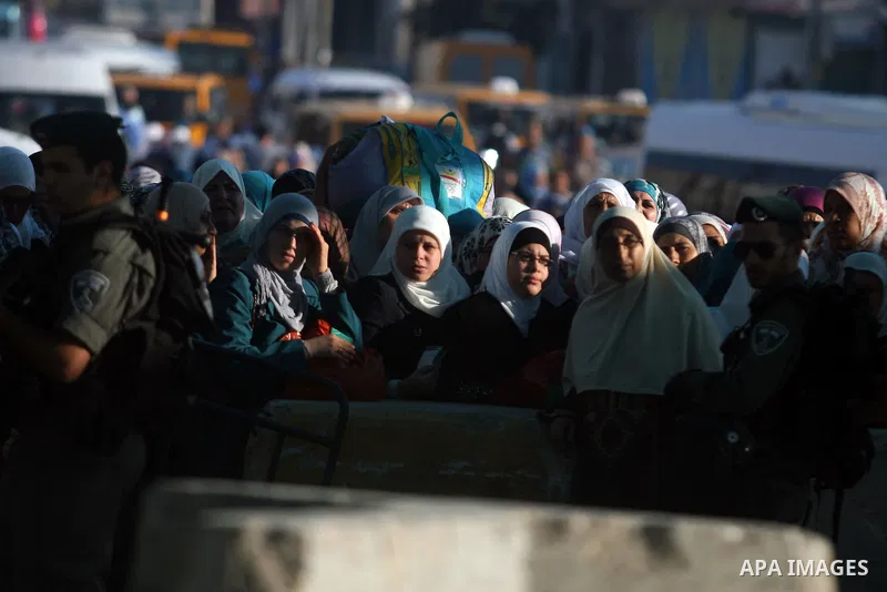 Palestinians wait to cross to Jerusalem from the Qalandia checkpoint near the West Bank city of Ramallah on Aug. 3, 2012. Palestinian Muslims are heading to Jerusalem to attend the third Friday prayers of the fasting mon...