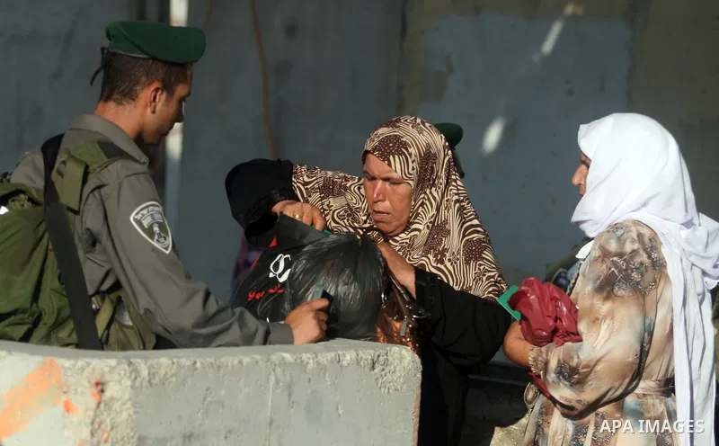 Palestinians cross to Jerusalem from the Qalandia checkpoint near the West Bank city of Ramallah on Aug. 3, 2012. Palestinian Muslims are heading to Jerusalem to attend the third Friday prayers of the fasting month of Ra...