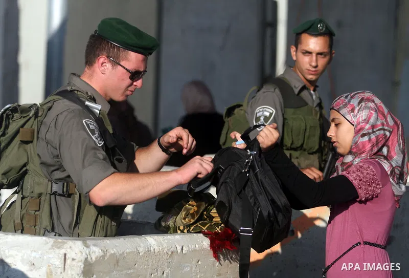 Palestinians cross to Jerusalem from the Qalandia checkpoint near the West Bank city of Ramallah on Aug. 3, 2012. Palestinian Muslims are heading to Jerusalem to attend the third Friday prayers of the fasting month of Ra...