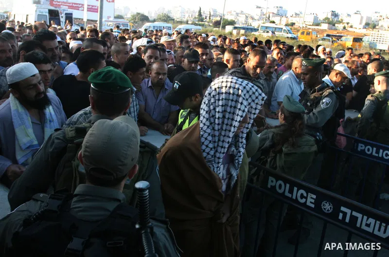 Palestinians cross to Jerusalem from the Qalandia checkpoint near the West Bank city of Ramallah on Aug. 3, 2012. Palestinian Muslims are heading to Jerusalem to attend the third Friday prayers of the fasting month of Ra...
