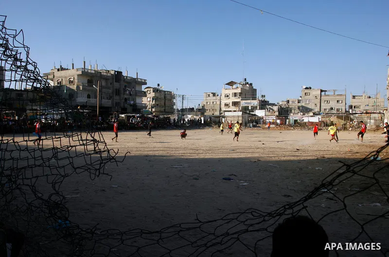 Palestinian youths play football before breaking fast in southern Gaza strip town of Rafah, on 03 August 2012. Muslims fasting in the month of Ramadan must abstain from food, drink and sex from dawn until sunset. Photo b...
