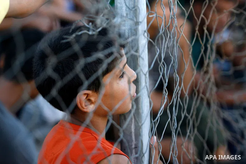 Palestinian youths watch a football match before breaking fast in southern Gaza strip town of Rafah, on 03 August 2012. Muslims fasting in the month of Ramadan must abstain from food, drink and sex from dawn until sunset...