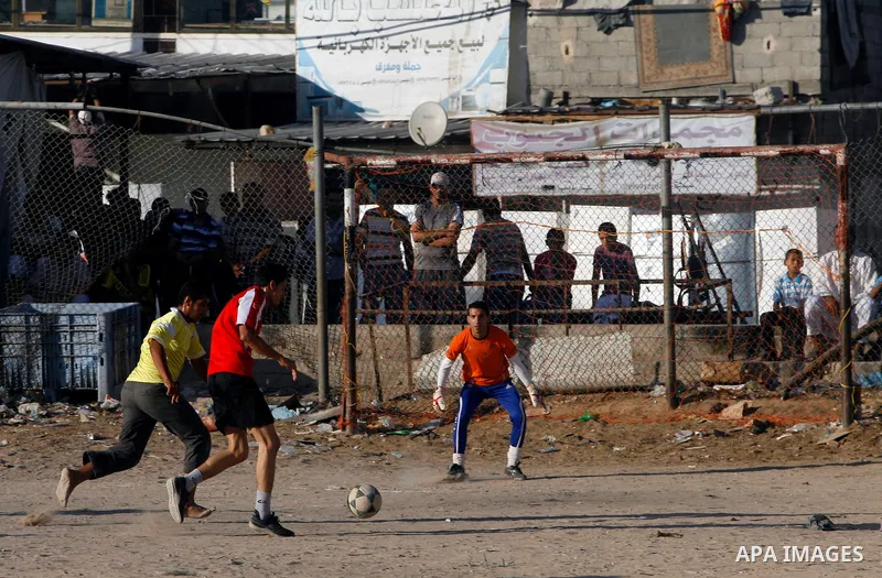 Palestinian youths play football before breaking fast in southern Gaza strip town of Rafah, on 03 August 2012. Muslims fasting in the month of Ramadan must abstain from food, drink and sex from dawn until sunset. Photo b...