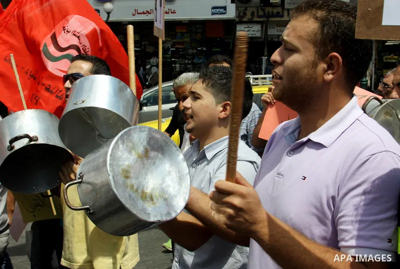 Palestinian demonstrators bang on pots during protest against rising prices and taxes in the West Bank, city of Nablus Aug. 04, 2012. Photo by Nedal Eshtayah