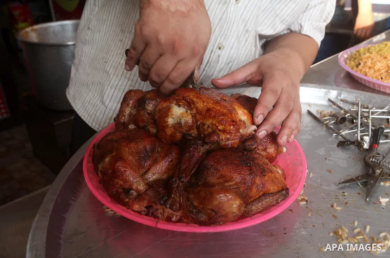 Palestinians prepare chicken as they wait for customers several hours before Iftar, the breaking of the day long Ramadan fast in Gaza City, on Aug. 04, 2012. Muslims around the world refrain from eating, drinking and sex...