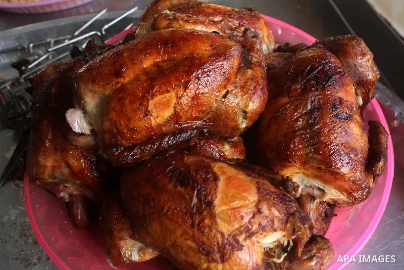 Palestinians prepare chicken as they wait for customers several hours before Iftar, the breaking of the day long Ramadan fast in Gaza City, on Aug. 04, 2012. Muslims around the world refrain from eating, drinking and sex...
