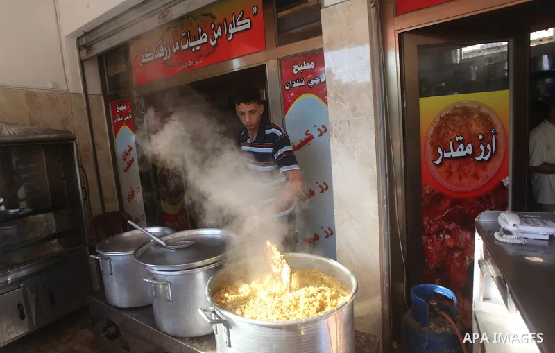 Palestinians prepare rice as they wait for customers several hours before Iftar, the breaking of the day long Ramadan fast in Gaza City, on Aug. 04, 2012. Muslims around the world refrain from eating, drinking and sexual...