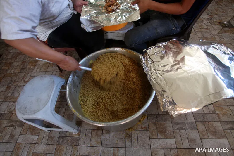 Palestinians prepare rice as they wait for customers several hours before Iftar, the breaking of the day long Ramadan fast in Gaza City, on Aug. 04, 2012. Muslims around the world refrain from eating, drinking and sexual...